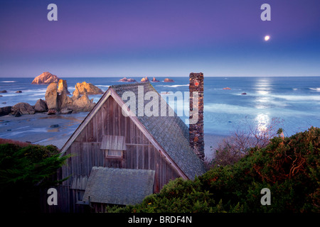 Cabin overlooking Bandon beach with moon set. Bandon, Oregon Stock Photo