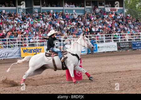 Cowgirl riding fast during barrel racing, Strathmore Heritage Days, Rodeo, Strathmore, Alberta, Canada Stock Photo