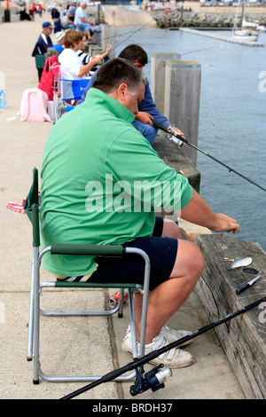 A man rod fishing showing his first catch of Mackerel at West Bay in Dorset  Stock Photo - Alamy