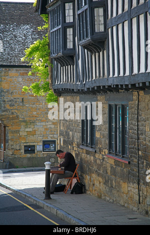 Street musician playing a dulcimer in Cheap Street Sherborne Dorset England UK Stock Photo