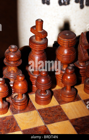 Wooden Chess Pieces King Queen and Pawns an ancient Board game Stock Photo