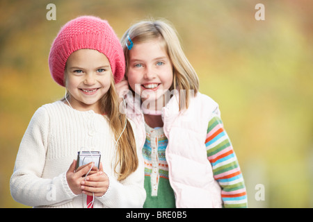 Two Young Girl Outdoors With MP3 Player Stock Photo