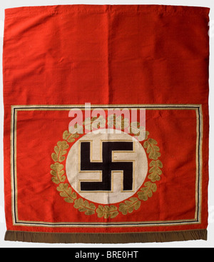 Adolf Hitler - a tapestry, from the Brown House in Munich Heavy version made of red fabric, in the centre a gold-bordered, upright black swastika in a white disc surrounded by gold oak leaf embroidery. Rectangular, black-white-golden border. Fringe trim on the lower edge. The upper edge with a broad hem, inside a sleeve for the wall hanging rod. Small damages, the red silk backing with repairs. Size 220 x 190 cm. From a series of tapestries from Adolf Hitler's personal meeting room in the party building complex "Braunes Haus" in Munich, Briennerstr. 45. Cf. Her, Stock Photo