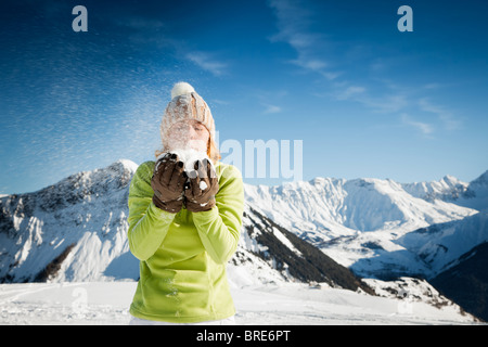 woman blowing on snow. Copy space Stock Photo