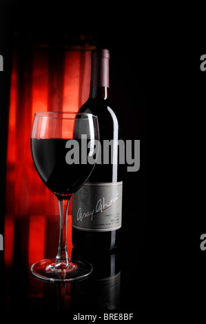 Virginia Wine, Gray Ghost Merlot bottle and glass with dark red background. Stock Photo