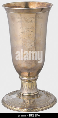 Franz Xaver Schwarz (1875 - 1947), a silver goblet, celebrating 10 Years as National Treasurer for the NSDAP, 1935 Gahr Workshop, Munich. Hand-hammered, silver goblet, partially gilded with the party eagle on the front above the engraved date '27.II. 1925 - 27.II 1935'. On the reverse the dedication 'Dem Reichsschatzmeister seine Mitarbeiter', (To the National Treasurer from His Colleagues) with fifteen signatures. The large base bears the surrounding inscription 'Treue um Treue' in relief and a swastika. A small silver plate on the bottom stamped with 'Gahr Mü, Stock Photo