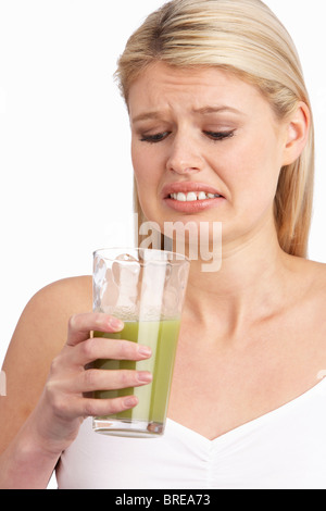 Young Woman Not Enjoying Healthy Drink In Studio Stock Photo