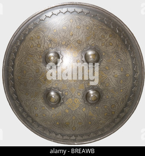 An Indian shield, Lahore, 19th century A cambered shield with fine gold and silver filled floral decoration. Reinforced rim. Four shield bosses in the centre with carrying loops on the back. Printed cloth backing and hand cushion are somewhat worn and bear the marks of age. Diameter 36 cm. historic, historical, 19th century, defensive arms, weapon, weapons, protective, protection, metal, armour suit, armor suit, suit of armour, piece, pieces, utensil, piece of equipment, utensils, shield, shields, object, objects, stills, clipping, clippings, cut out, cut-out, , Stock Photo