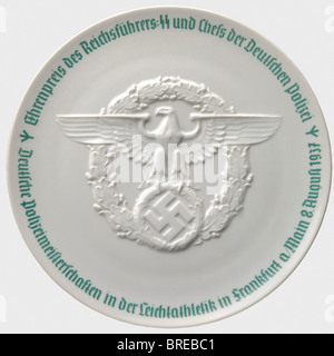 An award platter from the Reichsführer-SS and Chief of the German Police, German Police championships in track and field events 1937. White, glazed porcelain, with a police eagle in relief in the centre and a green circumscription along the border. The bottom bears the green, manufacturer's mark 'SS-Allach' in underglaze green. Diameter 24.5 cm. historic, historical, 1930s, 20th century, dishes, dish, plate, plates, object, objects, stills, clipping, clippings, cut out, cut-out, cut-outs, Stock Photo