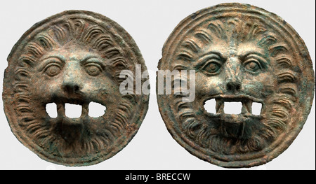 A pair of Roman lion head appliqués, 2nd/3rd century A.D. Slightly different round appliqués of sheet bronze with a heavy green patina. Finely embossed lion heads in relief with open work jaws. Cleaned excavation find. Diameters 18 and 19 cm. historic, historical, ancient world, ancient world, ancient times, object, objects, stills, clipping, cut out, cut-out, cut-outs, Stock Photo
