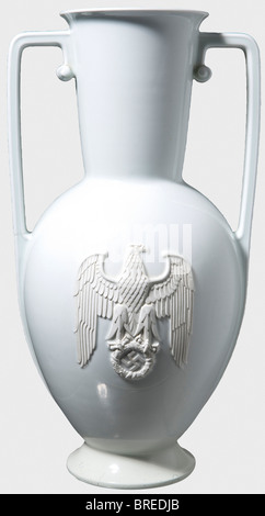 A large vase with handles, Allach Porcelain Factory Special model with the party eagle in relief. White, glazed porcelain, the detailed and finely modelled eagle unglazed. The manufacturer's mark impressed on the bottom. One handle with crack and firing flaw, the base restored. Height 57.5 cm. Only very little is known about this extremely rare special model, the form of which corresponds to the porcelain vase no. 506, that could be ordered with or without handles. Today, it is called 'the Reichs Chancellery Vase' with some justification, as it was quite likely, Stock Photo