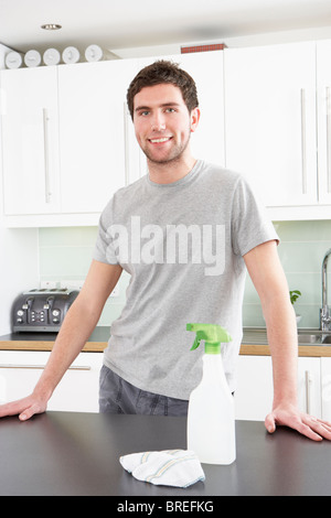 Portrait of smiling man cleaning the kitchen worktop at home Stock Photo -  Alamy