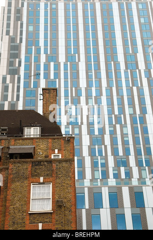 Nido student accommodation towering over traditional east London housing estate. Brune estate London E1 Stock Photo