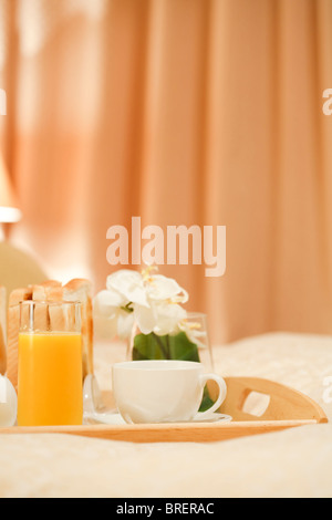 Coffee and orange juice on a tray in a luxury bedroom Stock Photo
