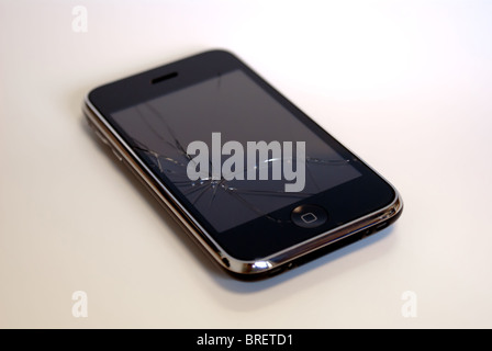 Apple iPhone with moderately cracked screen on white background Stock Photo