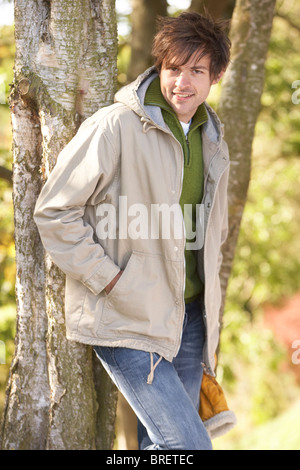 Young Man Outdoors Walking In Autumn Woodland Stock Photo