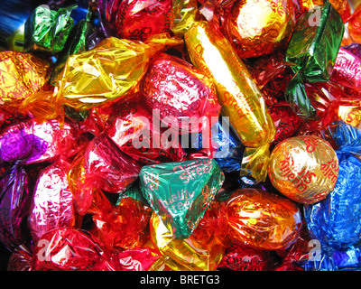 Assorted Quality Street chocolates in foil and cellophane wrappers. Stock Photo
