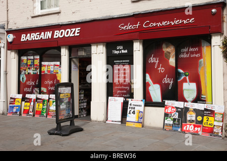 Bargain Booze shop front window with adverts for cheap alcohol. Wales, UK, Britain Stock Photo