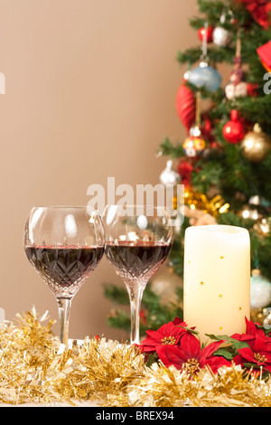 Dining room with festive decorations, christmas tree and crystal wine glasses