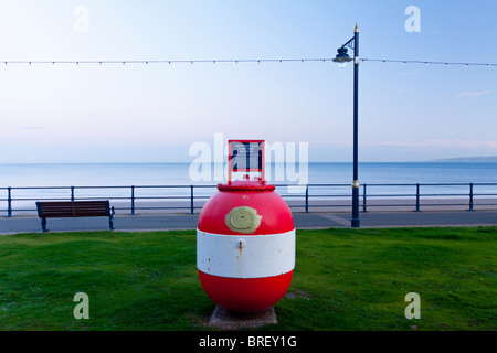 World War Two mine used as a collecting box by the Shipwrecked Mariners Society on the promenade at Filey in North Yorkshire UK Stock Photo