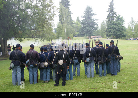 Union infantry line firing a volley, Civil War Battle Re-enactment, Port Gamble, WA Stock Photo