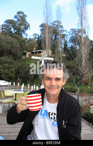 56 YEAR OLD MAN ENJOYING A CUP OF COFFEE BDA Stock Photo