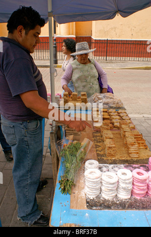 Woman buying sweets from a street vendor in Cholula, Puebla, Mexico Stock Photo