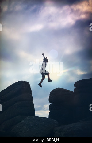 boy jumping on the rocks Stock Photo