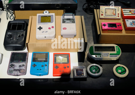 Different portable video game consoles on display during an exhibition of video games; including the famous Nintendo Game Boy. Stock Photo