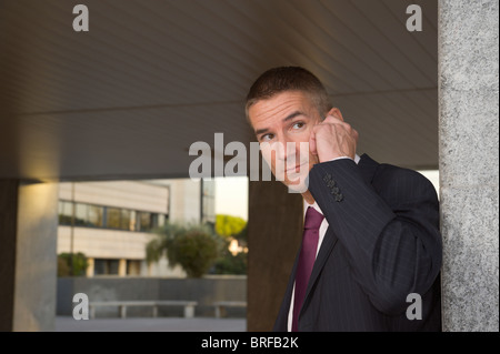 tough looking man in a suit, talking on mobile (cellular) phone, business concept Stock Photo
