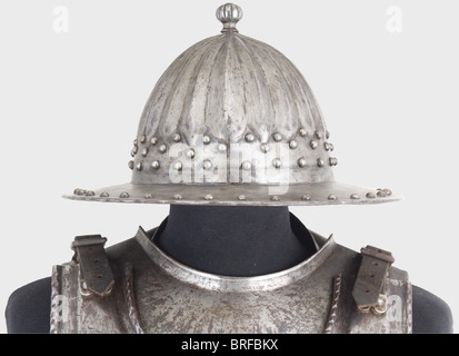 An English suit of armour for a man-at-arms, circa 1650, made of original and reproduction pieces. A helmet with forged segmented skull, an attached brim with turned-under edge, richly provided with decorative rivets. Baluster shaped top spike, and a riveted plume socket on the back. A gorget that opens on a hinge. An original back plate. A more recent, ridged breastplate with turned-under and corded rims. One of the attached tassets (with simulated lames) is original. All pieces are black lacquered on the inside. Height without helmet ca. 78 cm. historic, hist, Stock Photo