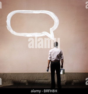 man with speech bubble painted on wall Stock Photo