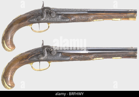 A pair of percussion pistols,Johann Andreas Keuchenreuter,Steinweg near Regensburg,circa 1760.Smooth bore,reblued barrels in 12 mm calibre with silver 'spider' front sights and two-piece folding rear sights.A chiselled hunting scene in relief on the breeches with brass-filled rider marks(Stöckel,No.7717).The sighting flats are signed,'IOH.AND.KUCHENREUTER' in gold and silver.Percussion locks nicely converted from flint,with stags in front of a forest backdrop cut into the lock plates in relief.Single set triggers.Lavishly carved walnut stocks(,Additional-Rights-Clearences-Not Available Stock Photo