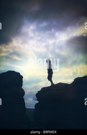 boy standing on rocks Stock Photo