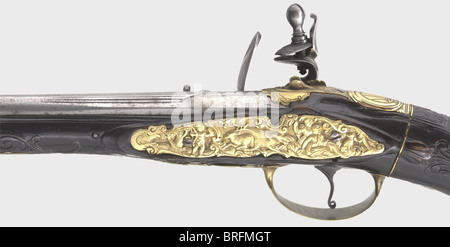 A muzzle-loading air pistol,Franz Heinz,Sternberg/Moravia,circa 1730.Round barrel with sighting flat and brass insert in 9 mm calibre.Silver inlaid vine decoration and the signature 'FRANTZ HEINZ' on the base of the barrel.Engraved simulated flintlock with an additional signature and the inscription 'IN STERNBERG'.Carved walnut stock with a screw-in buttstock and air reservoir.Brass furniture.The lock plate displays relief engravings of hunting themes.Original wooden ramrod with brass tip.Length 52 cm.Franz Heinz,Sternberg in Moravia,ca.1690 - 17,Additional-Rights-Clearences-Not Available Stock Photo