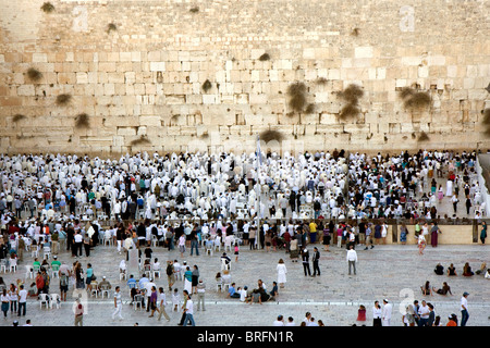 Jewish religious man with traditional clothes pray at the Wailing Wall in the old city of Jerusalem at Yom Kippur Stock Photo