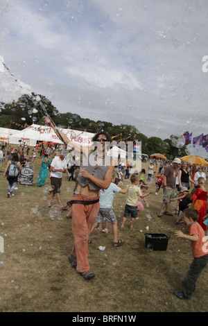 Bubble man spreads a little happiness at Camp Bestival, the family-friendly music festival at Lulworth Castle, Dorset Stock Photo