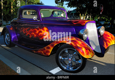 American Hot Rod with flaming paint job parked on street in small town America. Stock Photo