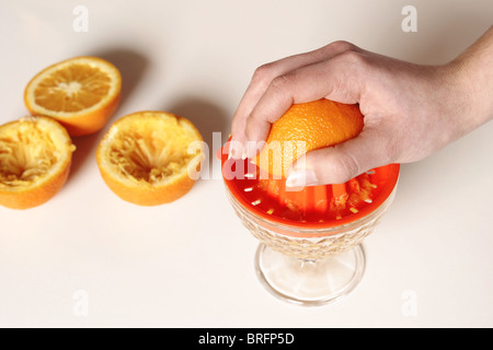 Woman with orange presses Stock Photo