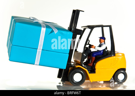 A toy forklift truck delivering a wrapped present
