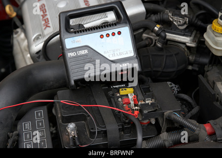 mains car battery charger charging flat car battery in cold weather Stock Photo