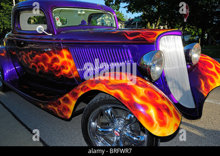 American Hot Rod with flame paint job on purple parked in small town America. Stock Photo