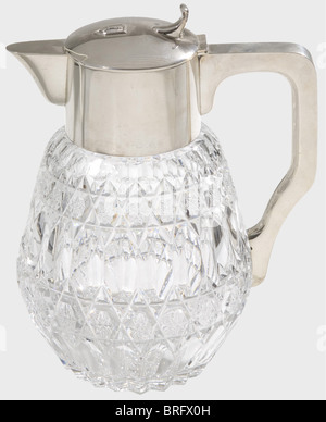 Hermann Göring,a silver carafe with lid,from his table service A large carafe of star-shaped cut lead crystal,the upper part and handle made of polished sterling silver. The lid bears the large Göring family coat of arms in relief. The bottom edge has the hallmark '925' and the master's mark,'HB'. Height 30.5 cm. Provenance: Keith Wilson Collection,Kansas City. Impressive water carafe from the Carinhall table silver.,historic,historical,1930s,1930s,20th century,NS,National Socialism,Nazism,Third Reich,German Reich,Germany,German,National Socia,Additional-Rights-Clearences-Not Available Stock Photo