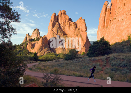 Woman walking for exercise in early morning, South Gateway Rock, Garden of the Gods, Colorado Springs, Colorado, USA Stock Photo