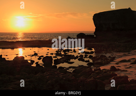 Sunset at Praia de Lourenco beach on the coast of Algarve near Armacao De Pera and Albufeira Stock Photo