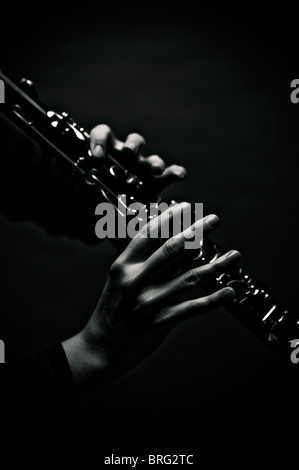 Two hands of a clarinetist playing a clarinet. Stock Photo