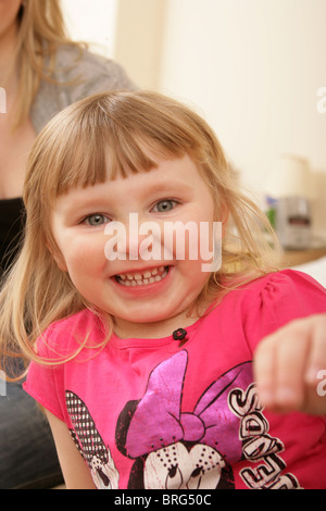 Cute three year old child smiling towards the camera. Stock Photo