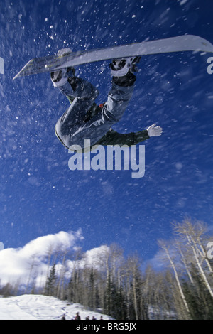 Male snowboarder flying through the air. Stock Photo