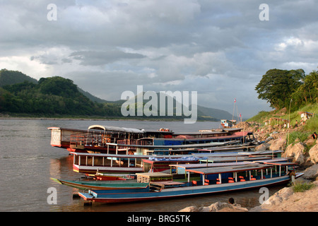 Boats are moored along the banks of the Mekong River in Luang Prabang, Laos. Stock Photo