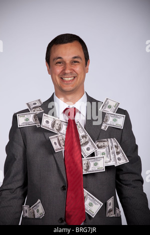 Happy and rich businessman showing all his money Stock Photo